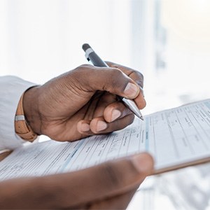 A patient filling out an insurance form