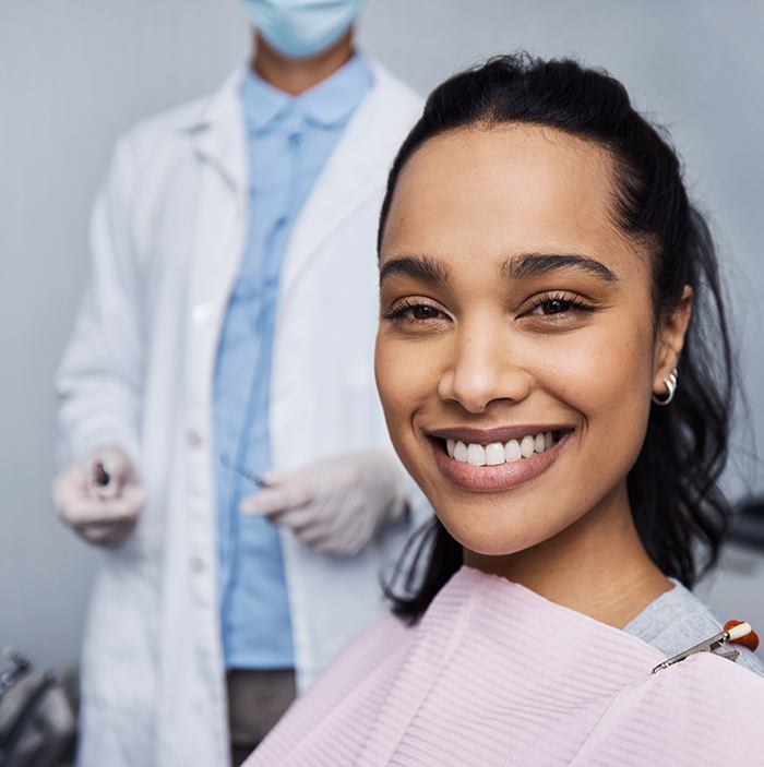 Woman smiling while sitting in treatment chair