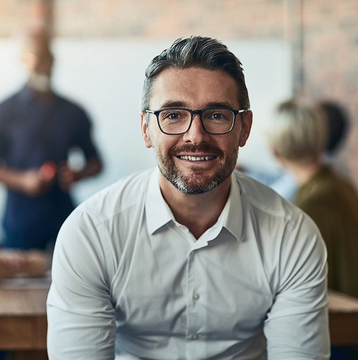 a smiling man with glasses