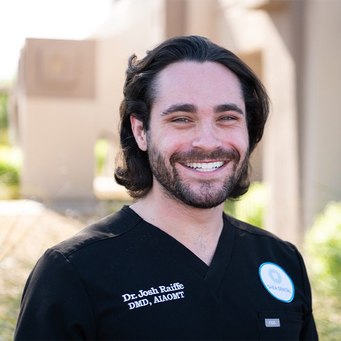 Scottsdale Arizona dentist Doctor Josh Raiffe grinning in front of Shea Dental of Scottsdale