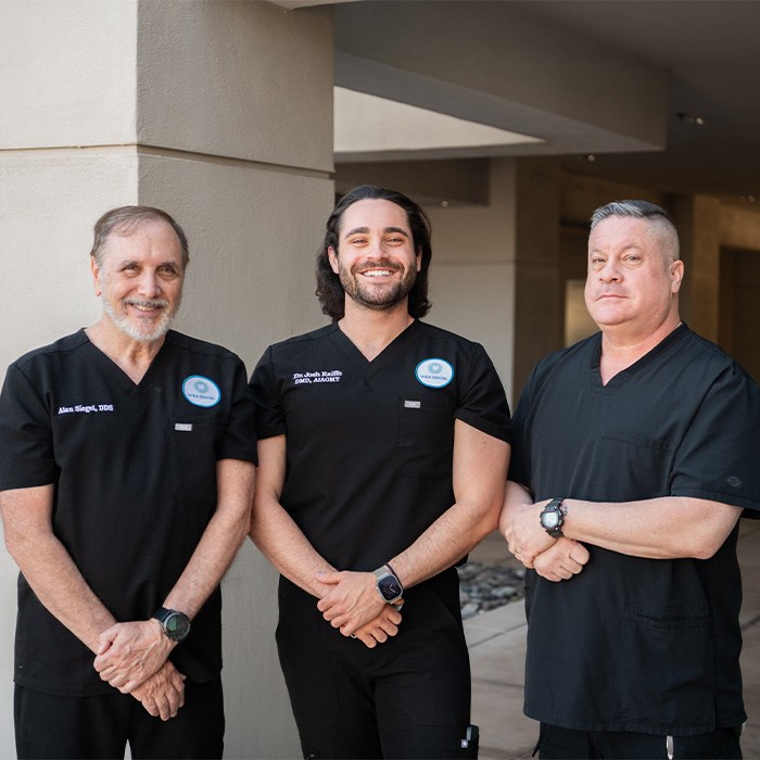 Doctor Raiffe and Doctor Siegel shaking hands in front of Shea Dental of Scottsdale