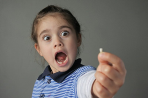 Child freaking out at seeing her baby tooth